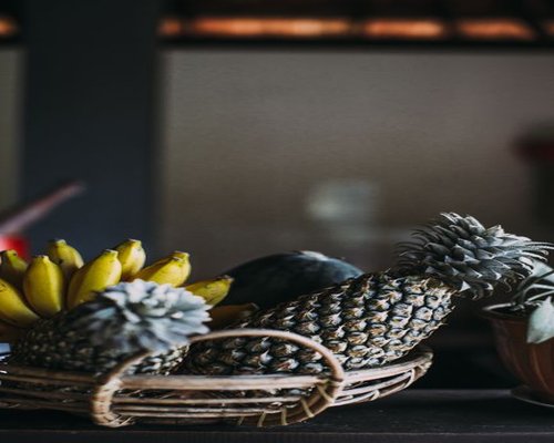 A high angle shot of clean fresh tropical fruits like salak and pineapples beautifully arranged for a lifestyle breakfast
